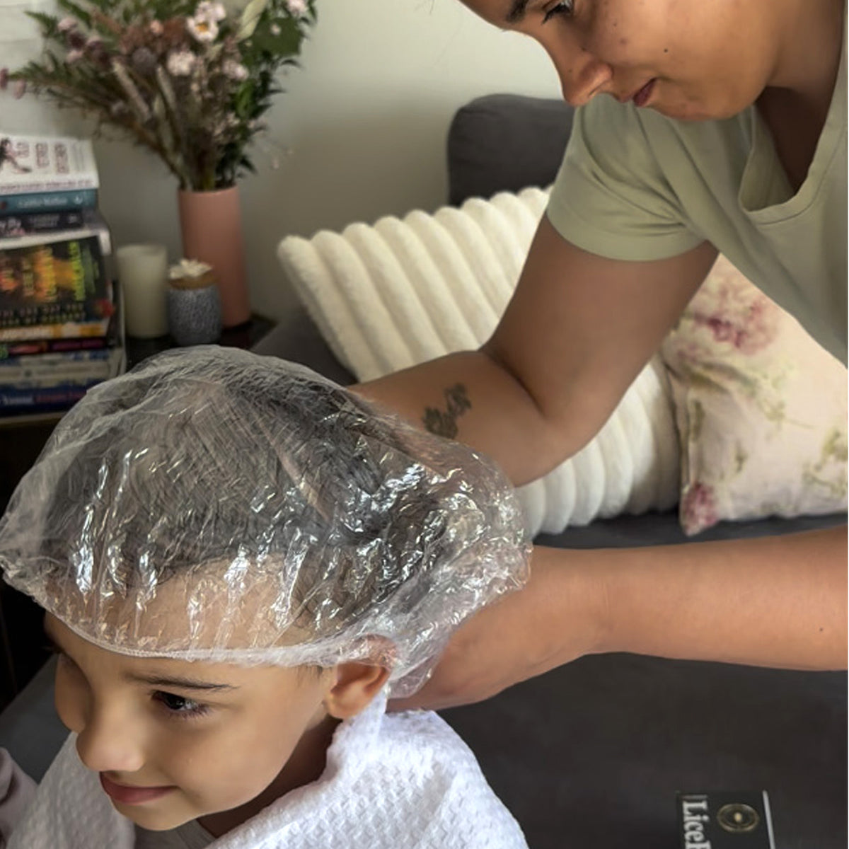 Hair covered with a cap during the LiceBomb head lice treatment process